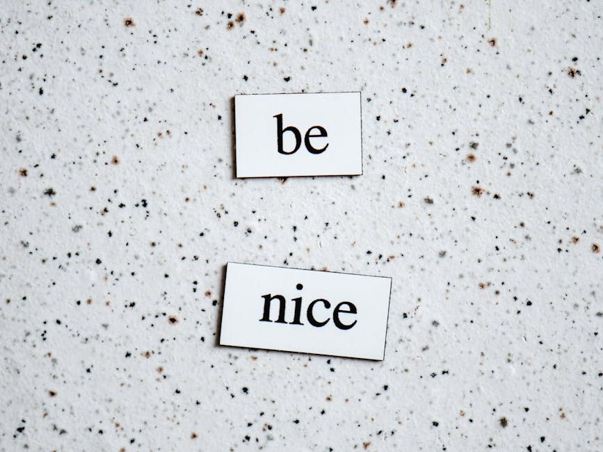 Two words printed on small tiles: "be" and "nice".